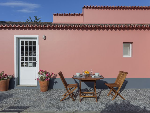  House accommodations/lodging at Quinta dos Peixes Falantes: exterior façade with entrance door and patio seating