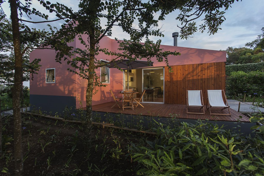 House accommodations/lodging at Quinta dos Peixes Falantes: exterior view of deck with lounge chairs and patio seating from garden