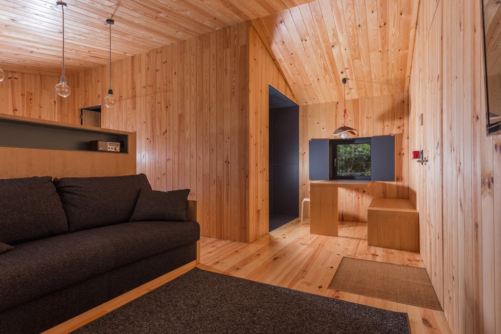 Studio accommodations/lodging at Quinta dos Peixes Falantes: modern living- and dining-room finished in rich timber