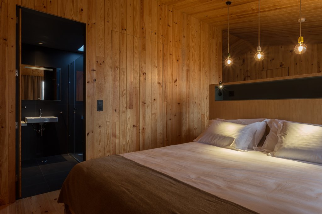 Studio accommodations/lodging at Quinta dos Peixes Falantes: modern bedroom finished in rich timber with access to bathroom