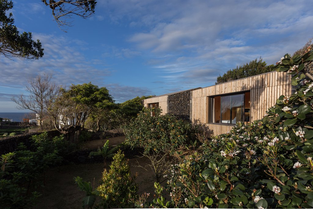 Studio accommodations/lodging at Quinta dos Peixes Falantes: studio exteriors finished in timber slats and dense gardens
