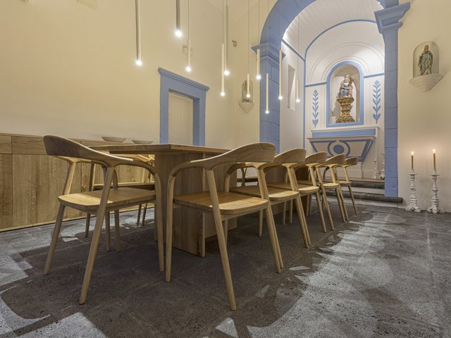 Renovated chapel at Quinta dos Peixes Falantes, São Miguel, Azores (Portugal): oblique view interior of alter and dining table