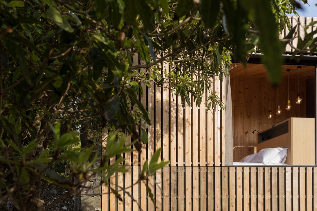 Studio accommodations/lodging at Quinta dos Peixes Falantes: exterior façade finished in timber slats and large open picture window