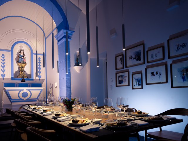 Renovated chapel at Quinta dos Peixes Falantes, São Miguel, Azores (Portugal): somber lighting highlighting alter and dining table